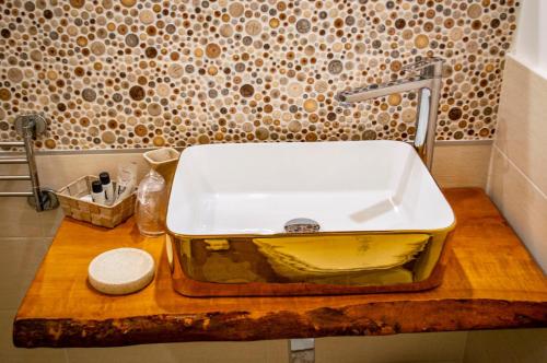 a white sink on a wooden counter in a bathroom at Alterego B&B in Milazzo