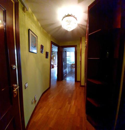 an empty hallway with a chandelier in a house at Apartamento Fomento in Gijón