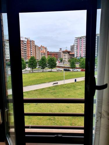 a view of a park from a window at Apartamento Fomento in Gijón