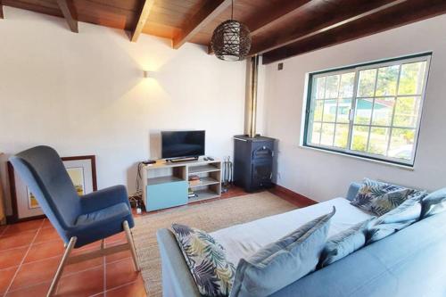 a living room with a couch and a chair at Secluded Beach House @Praia da Galé in Melides