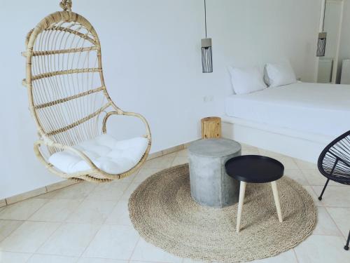 a room with a rattan chair and a bed at Gardenia in Stavros