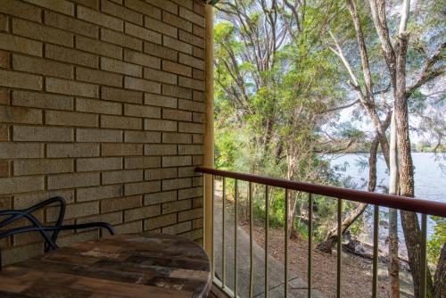 a balcony with a table and a view of the water at Nightcap at Northern Grounds in Maroochydore