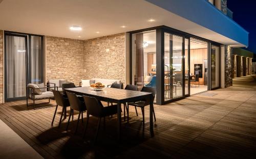a dining room with a table and chairs at Villa Eola Hvar in Jelsa