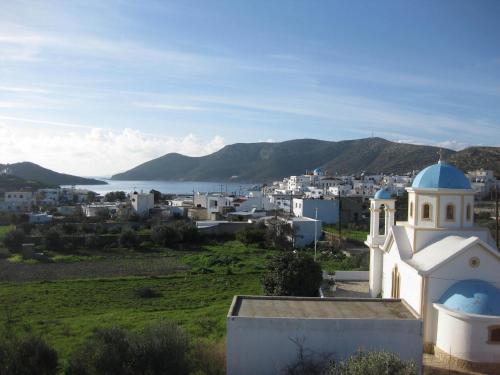 a white building with a blue dome on top of it at Kalypso Apartments in Lipsoi