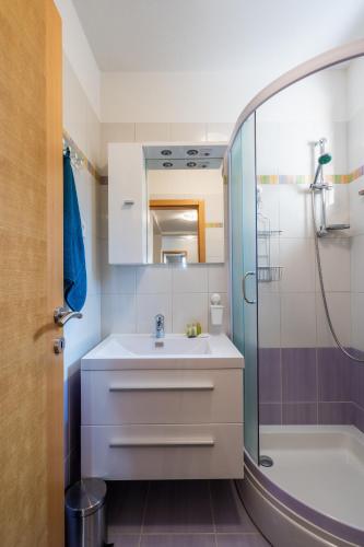 a bathroom with a sink and a shower at Downtown Apartment Helena in Opatija