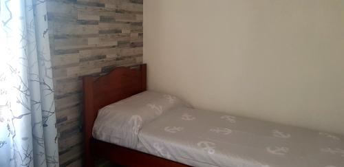a small bedroom with a bed and a window at Appartamento Alissya in Tortolì
