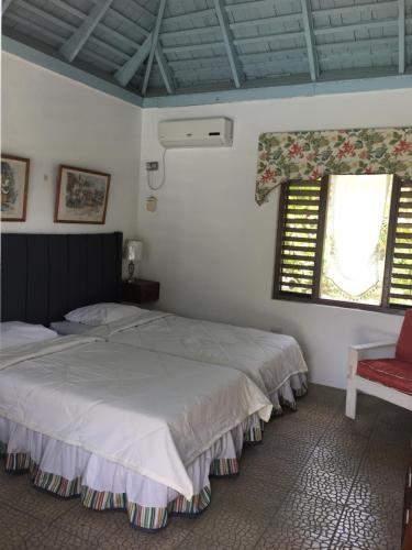 A bed or beds in a room at Reef Winds Villa