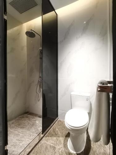a bathroom with a toilet and a shower at Paco Hotel Jinfeng Metro Guangzhou-Free Shuttle Bus For Canton Fair-Self-service laundry in Guangzhou