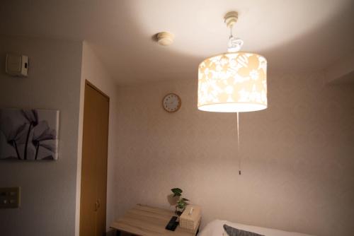 a light hanging from a ceiling in a room at Vail sta Takenotsuka in Tokyo