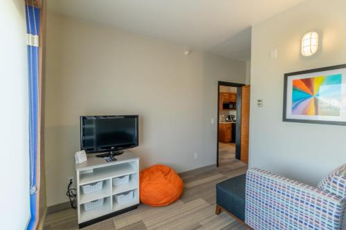 a living room with a tv and a chair at Holiday Inn Express Hotel & Suites Limon I-70/Exit 359 by IHG in Limon