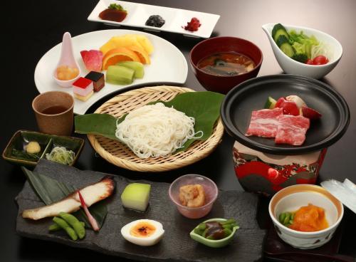a table with a bunch of food on it at Oyado Koto No Yume in Takayama