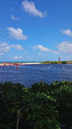 a large body of water with boats in it at Pousada Aconchego in Pitimbu
