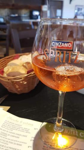 a glass of wine sitting on top of a table at ibis Chalon Sur Saone Nord in Chalon-sur-Saône