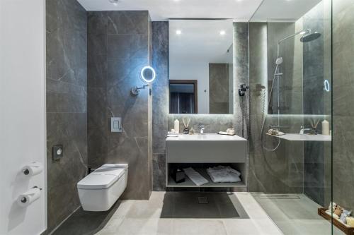 a bathroom with a sink and a toilet and a shower at Sky Blue Hotel & Spa in Ploieşti