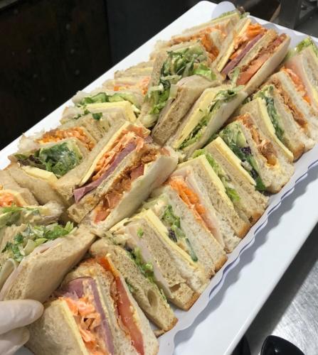 a white plate of sandwiches on a table at Parkside Inn Motel in Melbourne