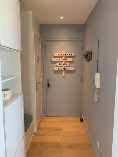 a hallway with a sign that reads enemies just pass him at La Baule Family in La Baule