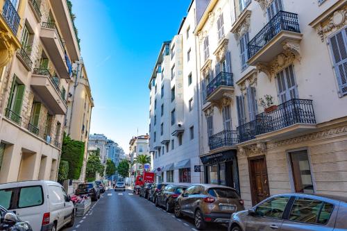 a city street with cars parked on the sides of buildings at Goldstar Apartments & Suites in Nice