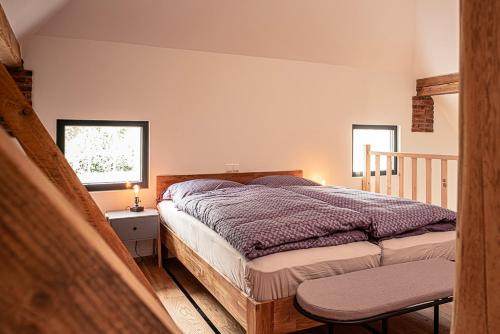 a bedroom with a bed and a table and a window at Landhaus Fiete in Ihlow