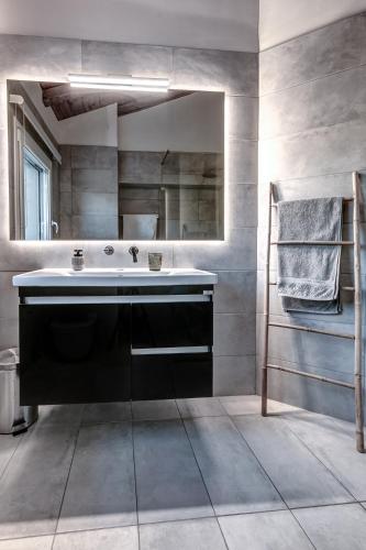 a bathroom with a large sink and a mirror at Ktima Loumoumba, Private Villa in Gouvia