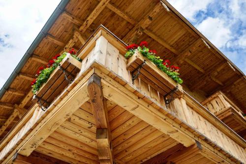 a wooden building with flower boxes on it at Haus Leiter in Reit im Winkl