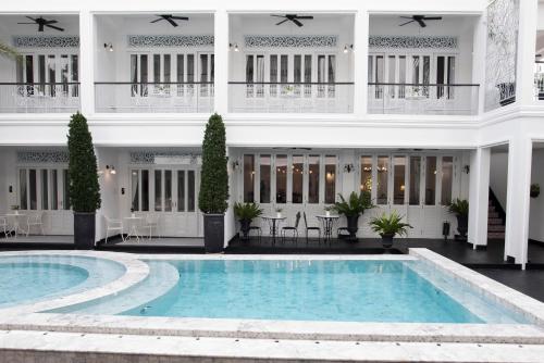 a large white swimming pool in front of a large white building at Noursabah Pattaya in Pattaya Central