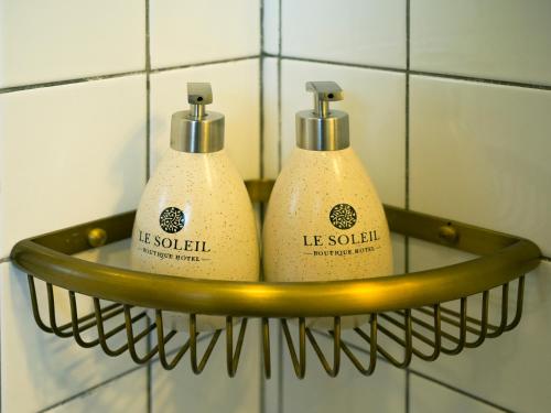 two toilets in a rack in a bathroom at Le Soleil Boutique Hotel in Da Lat