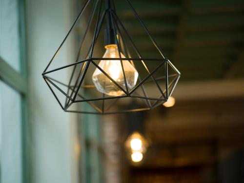 a glass light fixture hanging from a building at Le Soleil Boutique Hotel in Da Lat
