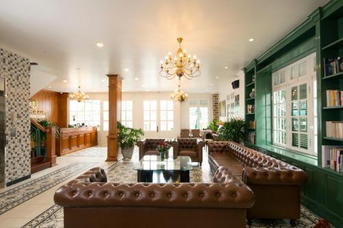 a large living room with a leather couch and a chandelier at Le Soleil Boutique Hotel in Da Lat
