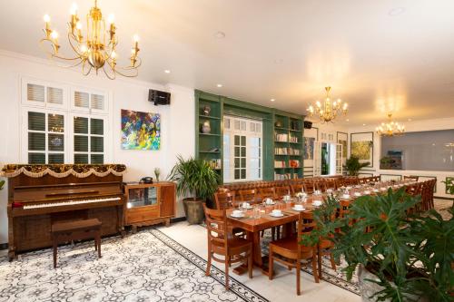 
a living room filled with furniture and a piano at Le Soleil Boutique Hotel in Da Lat
