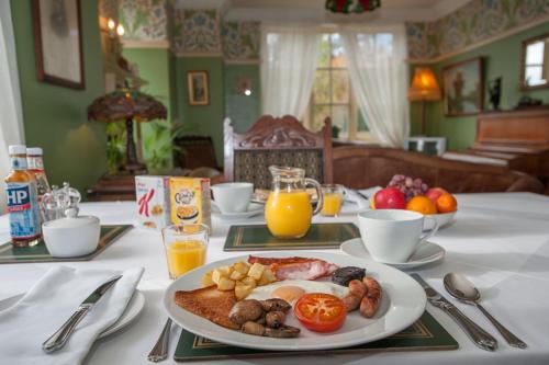 a table with a plate of breakfast food on it at Ardwyn House in Llanwrtyd Wells