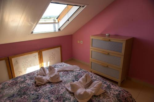 a bedroom with a bed with a dresser and a window at Ático con terraza en Graus-Pirineo de Huesca in Graus