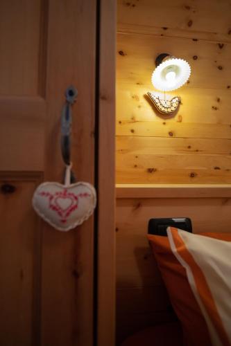 a mirror and a purse hanging on a wall at Chalet Mistral in Livigno