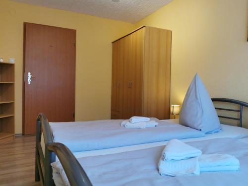 a bedroom with a bed with towels on it at Hotel Mainperle in Wertheim