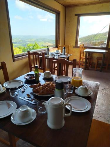 a table with food and coffee on it with a window at Casa Rural Haitzetxea in Zugarramurdi
