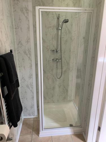 a shower with a glass door in a bathroom at Alandene in Blackpool