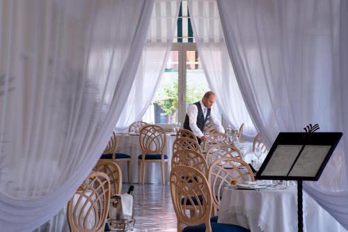 a table with two chairs and a laptop on it at Miramare E Castello in Ischia