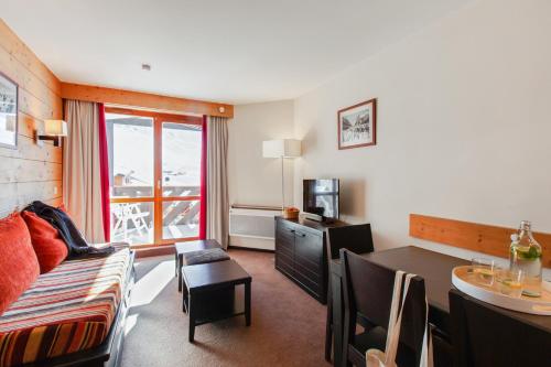 a living room with a couch and a table in a room at Résidence Pierre & Vacances Le Tikal in Val Thorens
