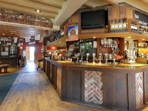 a bar in a pub with a lot of alcohol at The Tawny Owl in Swindon