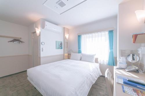 a bedroom with a large white bed and a window at Toyoko Inn Seoul Dongdaemun II in Seoul