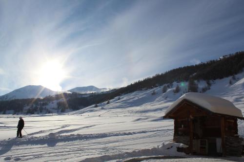 a person is skiing on a snow covered slope at Chalet Mistral in Livigno