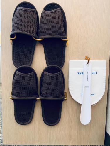 a pair of flip flops on a wall with a thermometer at Toyoko Inn Seoul Dongdaemun II in Seoul
