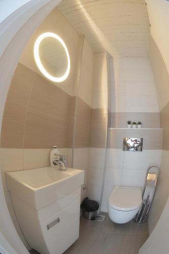a bathroom with a white toilet and a sink at St.Sava apartment in Belgrade