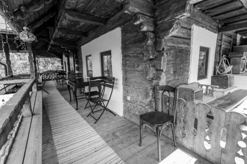 a room with chairs and a table in a cabin at Casa Poveste Pensiunea-Muzeu in Câmpulung Moldovenesc