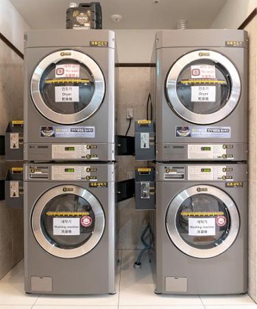 three washing machines sitting next to each other at Toyoko Inn Seoul Dongdaemun II in Seoul