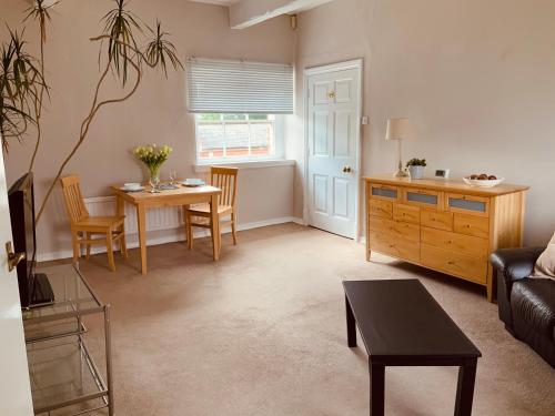 a living room with a couch and a table at The Stables Apartment in Newark upon Trent