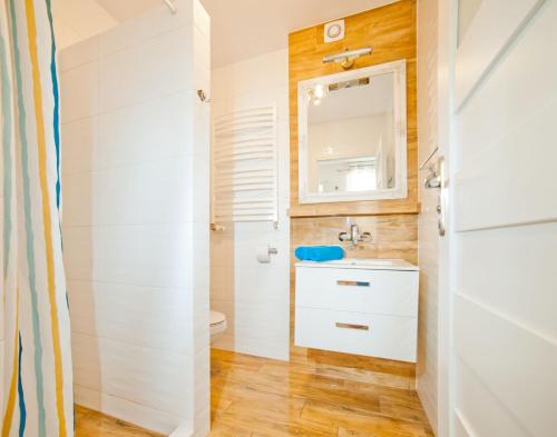 ein Bad mit einem Waschbecken und einem WC in der Unterkunft Bolesława Chrobrego 34 in Ustronie Morskie