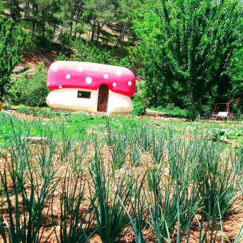 a pink and white inflatable house in a field at Krka Fairytale village in Rupe