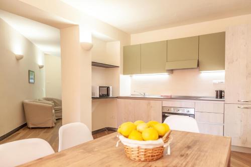a kitchen with a table with a basket of fruit at PORTOVECCHIO in Levanto
