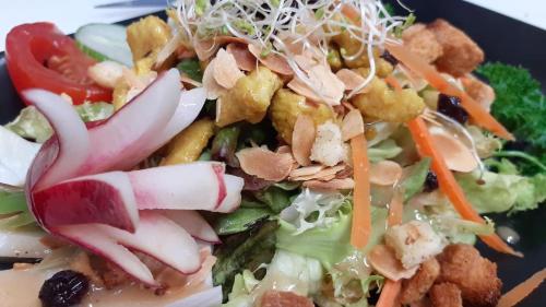 a plate of food with vegetables and other foods at La Boule d'or in Pouzauges