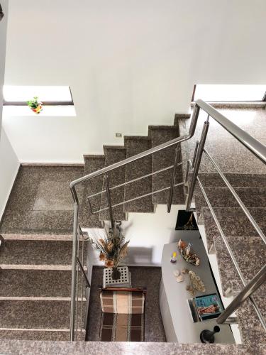 a staircase with a white couch and a table at Villa Anastasia in Costinesti